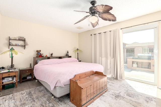 bedroom featuring access to exterior, visible vents, ceiling fan, and wood finished floors