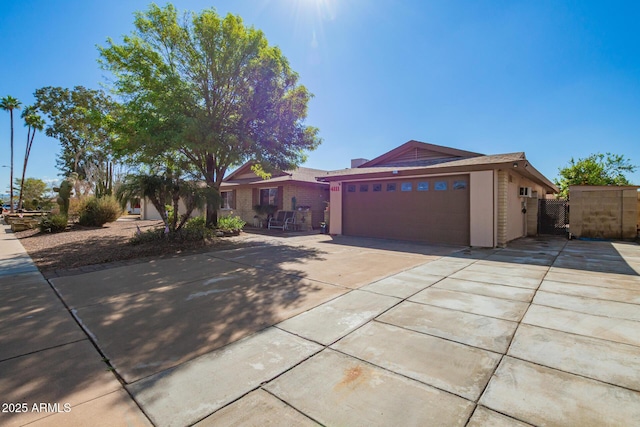 view of front of home with concrete driveway, an attached garage, and stucco siding