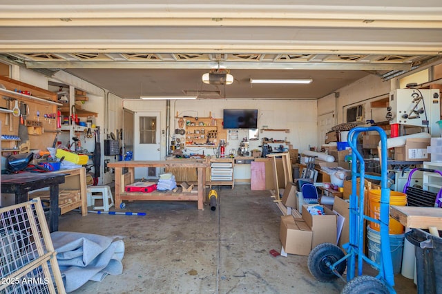 garage with a workshop area and a garage door opener