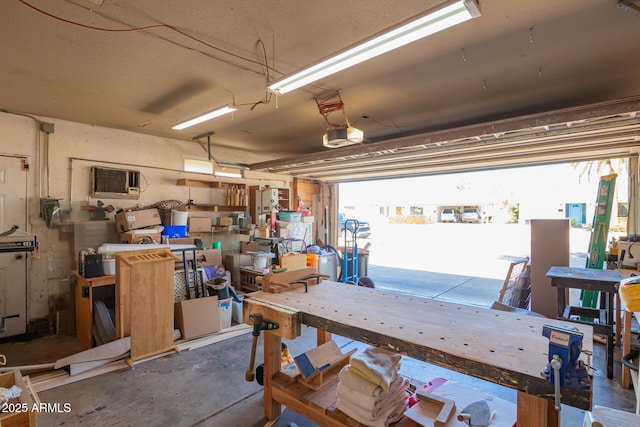 garage with a workshop area and a garage door opener