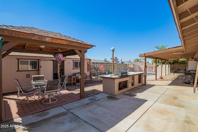 view of patio / terrace with a gazebo, outdoor dining space, grilling area, and fence