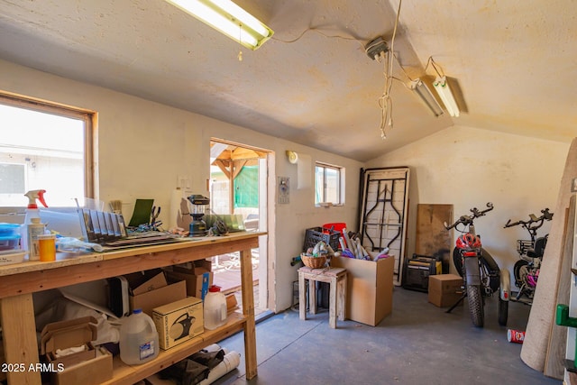 miscellaneous room with concrete floors and vaulted ceiling