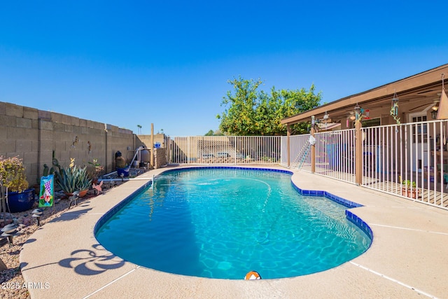 view of swimming pool featuring a fenced in pool, a fenced backyard, and a patio area