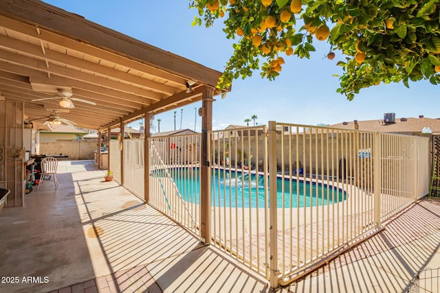 view of swimming pool featuring a ceiling fan, a patio area, fence private yard, and a fenced in pool