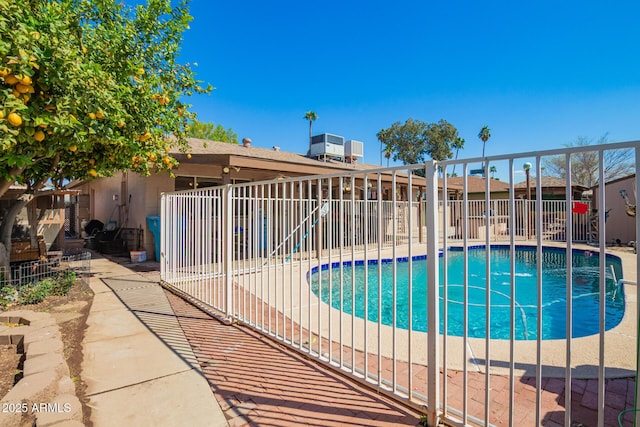 view of swimming pool featuring a fenced in pool and fence