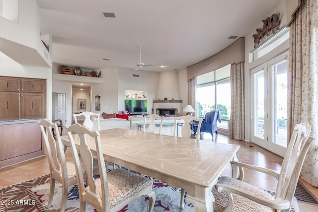 24801 N Vado Ct, Rio Verde, AZ 85263 - dining room featuring a fireplace, light wood-type flooring, and ceiling fan