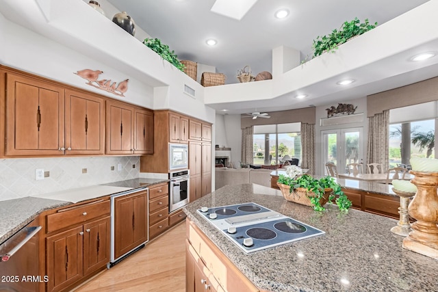 24801 N Vado Ct, Rio Verde, AZ 85263 - kitchen with appliances with stainless steel finishes, open floor plan, light stone countertops, tasteful backsplash, and recessed lighting