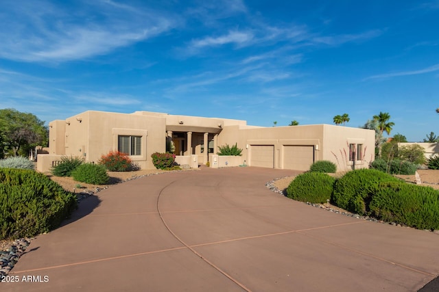 24801 N Vado Ct, Rio Verde, AZ 85263 - pueblo-style home with stucco siding, curved driveway, and a garage