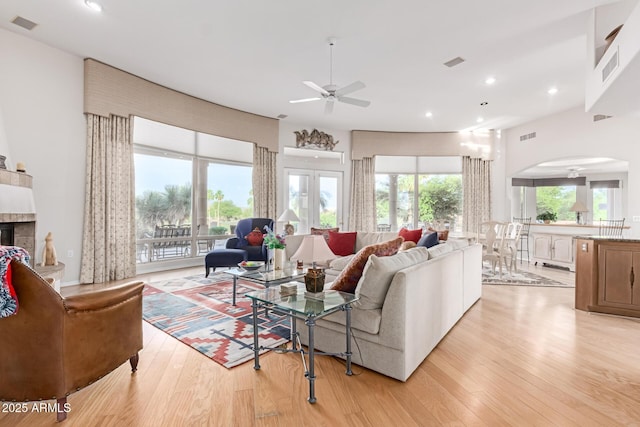 24801 N Vado Ct, Rio Verde, AZ 85263 - living room with ceiling fan, arched walkways, light wood-style flooring, a fireplace, and recessed lighting
