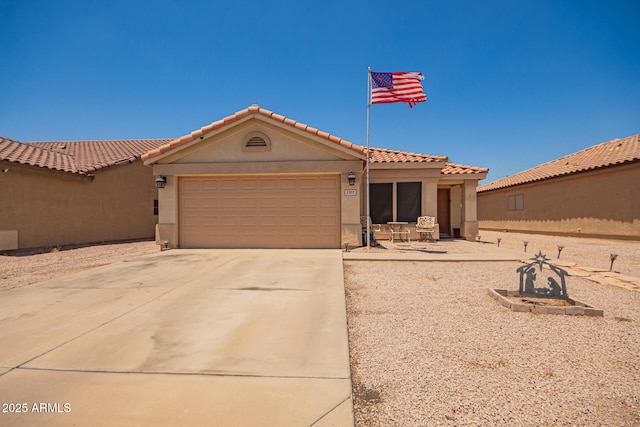 2202 S Lawther Dr, Apache Junction, AZ 85120 - mediterranean / spanish home with concrete driveway, an attached garage, stucco siding, and a tile roof