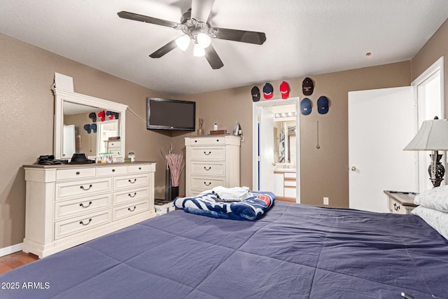 2202 S Lawther Dr, Apache Junction, AZ 85120 - bedroom featuring ceiling fan, light wood-style flooring, and connected bathroom