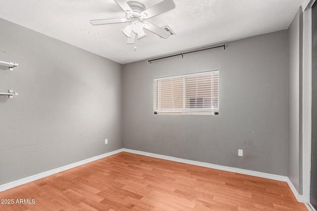 2202 S Lawther Dr, Apache Junction, AZ 85120 - empty room featuring wood finished floors, ceiling fan, and a textured ceiling