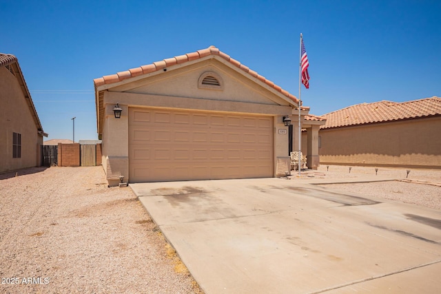 2202 S Lawther Dr, Apache Junction, AZ 85120 - view of front of house with driveway, a garage, a tiled roof, stucco siding, and a gate