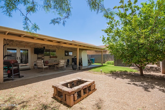 2202 S Lawther Dr, Apache Junction, AZ 85120 - back of house with an outdoor fire pit and a patio