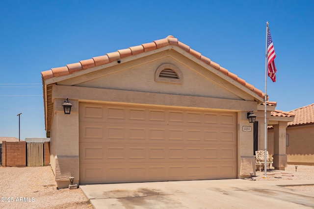 2202 S Lawther Dr, Apache Junction, AZ 85120 - view of front of property with an attached garage, a tiled roof, driveway, and stucco siding