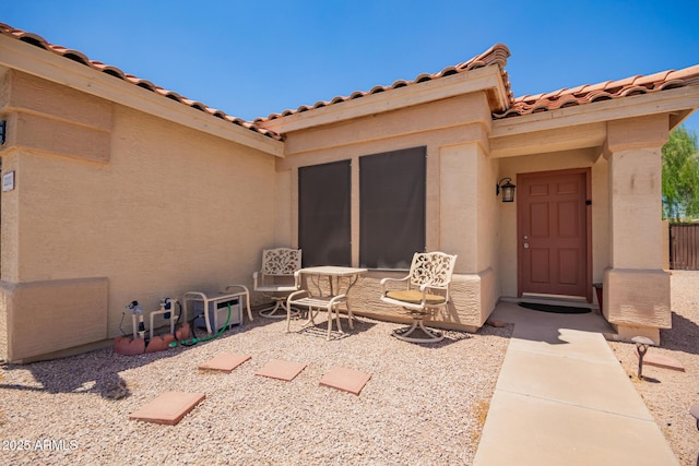 2202 S Lawther Dr, Apache Junction, AZ 85120 - doorway to property featuring stucco siding, a tile roof, and a patio