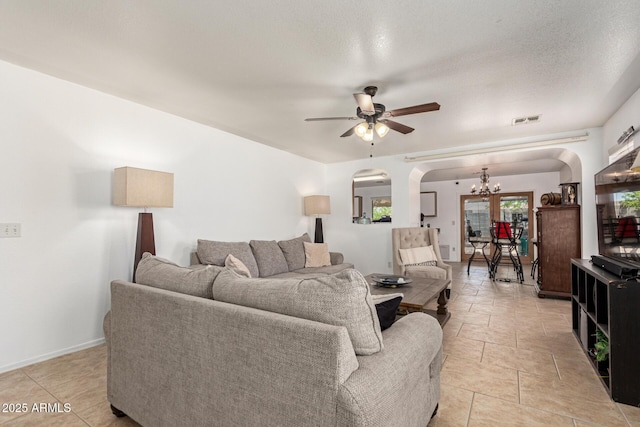 2202 S Lawther Dr, Apache Junction, AZ 85120 - living area featuring arched walkways, a chandelier, a ceiling fan, and light tile patterned floors
