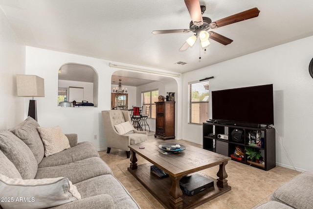2202 S Lawther Dr, Apache Junction, AZ 85120 - living room with arched walkways, a chandelier, a ceiling fan, and light tile patterned floors