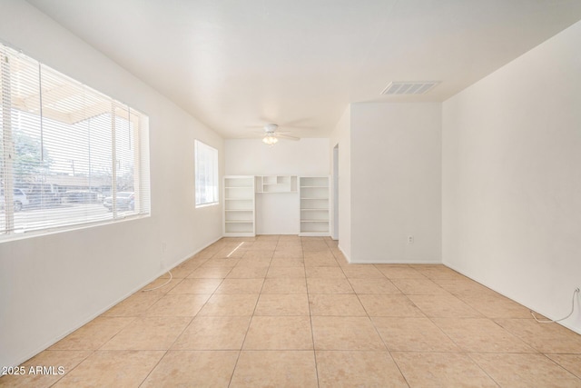 unfurnished room featuring light tile patterned floors, visible vents, and a ceiling fan