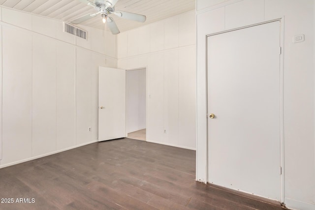 unfurnished bedroom featuring visible vents, a ceiling fan, and dark wood-style flooring