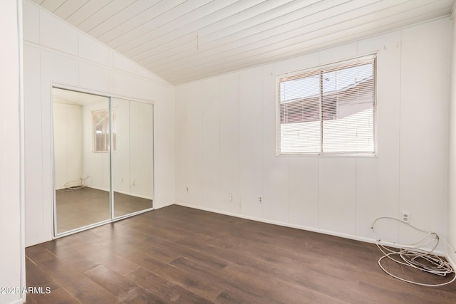 unfurnished bedroom with dark wood-type flooring, wood ceiling, a closet, and lofted ceiling