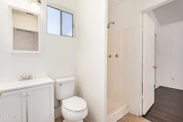 full bathroom featuring visible vents, toilet, a stall shower, wood finished floors, and vanity