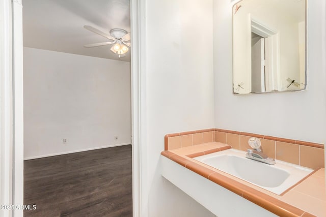 bathroom with wood finished floors, a ceiling fan, and a sink