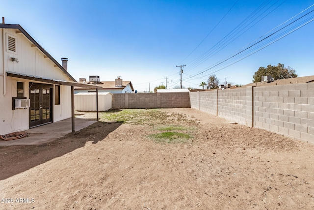 view of yard featuring cooling unit, a fenced backyard, and a patio