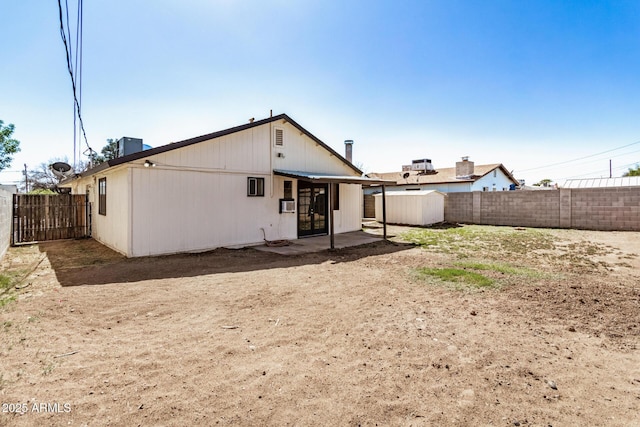 back of property with a patio and a fenced backyard