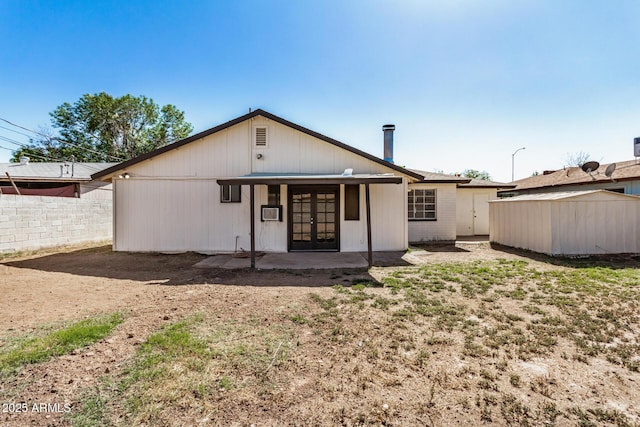 back of house featuring french doors and fence