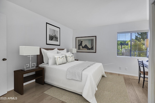 bedroom featuring baseboards and wood finished floors