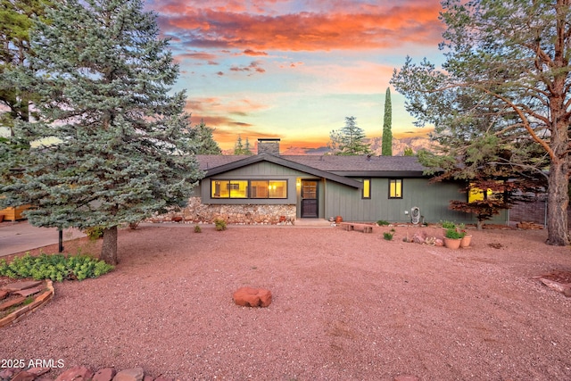 mid-century inspired home with a chimney and a shingled roof