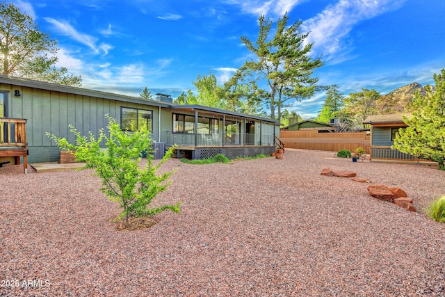 rear view of house with fence