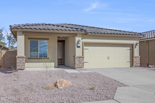 view of front of property featuring an attached garage, a tiled roof, concrete driveway, and stucco siding