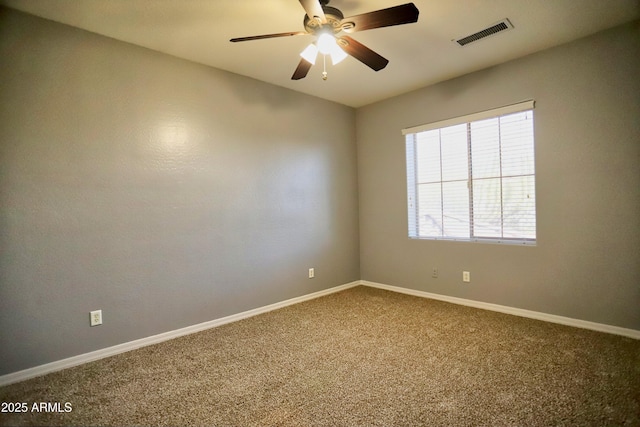 unfurnished room featuring a ceiling fan, carpet, visible vents, and baseboards