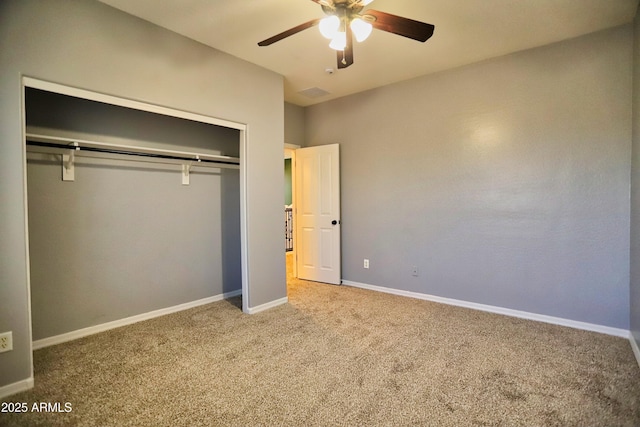 unfurnished bedroom with a ceiling fan, a closet, baseboards, and carpet flooring