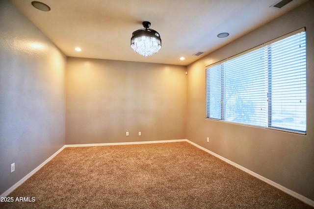 carpeted spare room with visible vents, baseboards, and recessed lighting