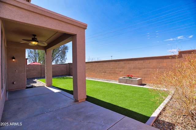 view of yard with a fenced backyard, a patio, and ceiling fan