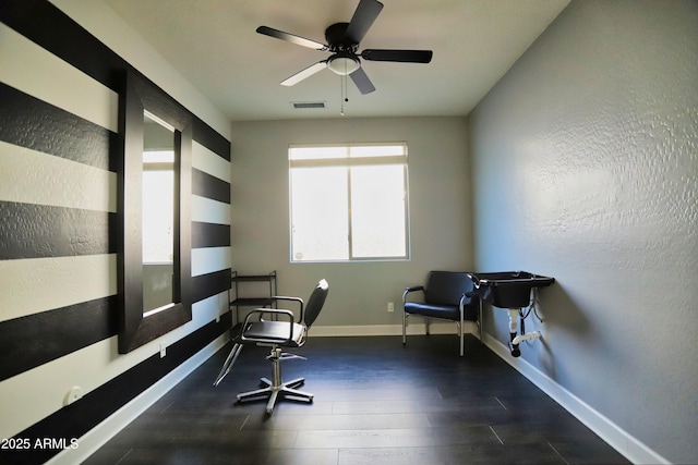 home office featuring visible vents, ceiling fan, baseboards, and wood finished floors