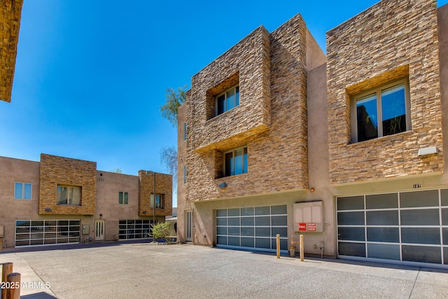 312 S Hardy Dr Unit 106, Tempe, AZ 85281 - view of building exterior with a garage and driveway