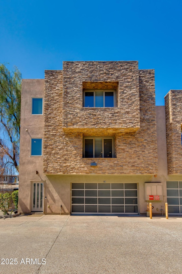 312 S Hardy Dr Unit 106, Tempe, AZ 85281 - view of property with an attached garage and driveway