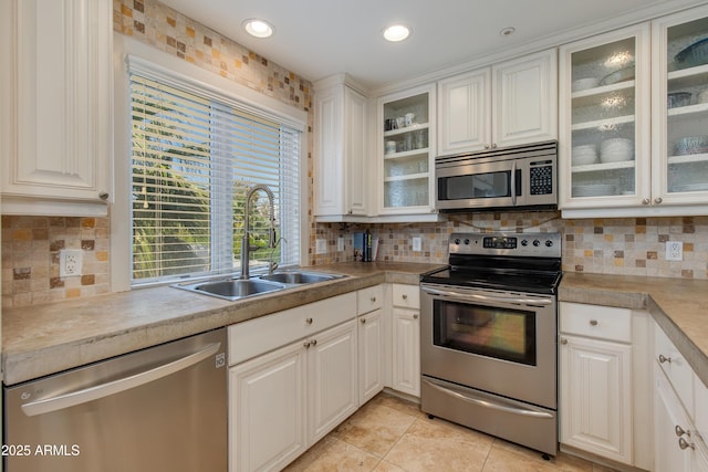 312 S Hardy Dr Unit 106, Tempe, AZ 85281 - kitchen with appliances with stainless steel finishes, backsplash, light countertops, light tile patterned flooring, and white cabinets