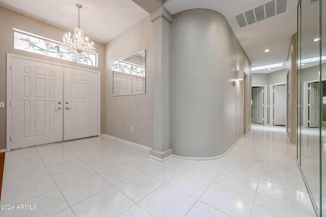 entrance foyer featuring a notable chandelier