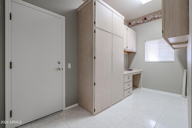 clothes washing area featuring a textured ceiling