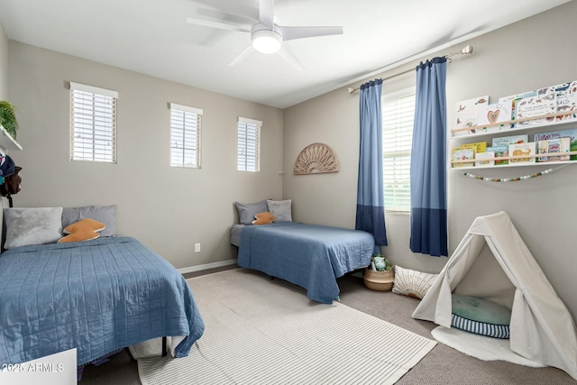 carpeted bedroom with baseboards and a ceiling fan