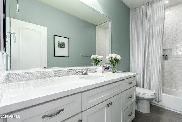 bathroom with toilet, vanity, and shower / bathtub combination with curtain