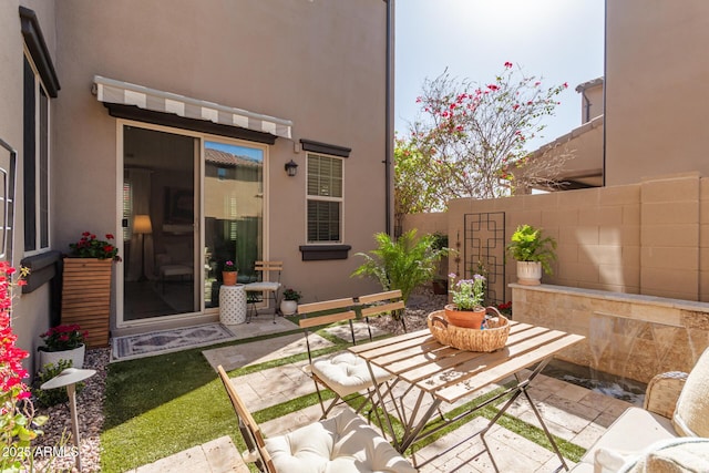 view of patio featuring fence