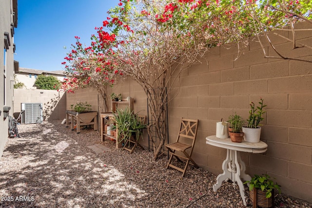 view of yard featuring central air condition unit and a fenced backyard