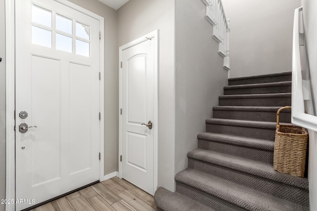 foyer featuring stairway and wood finish floors