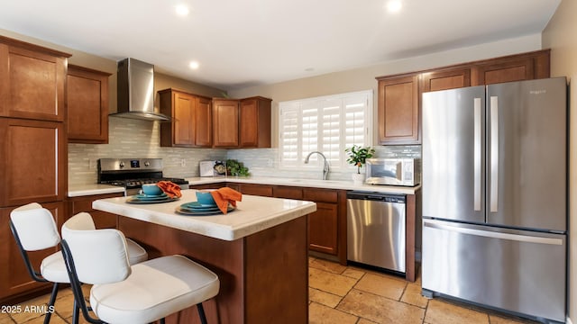524 W Fairway Dr Unit 10, Mesa, AZ 85201 - kitchen featuring appliances with stainless steel finishes, wall chimney range hood, a sink, tasteful backsplash, and recessed lighting